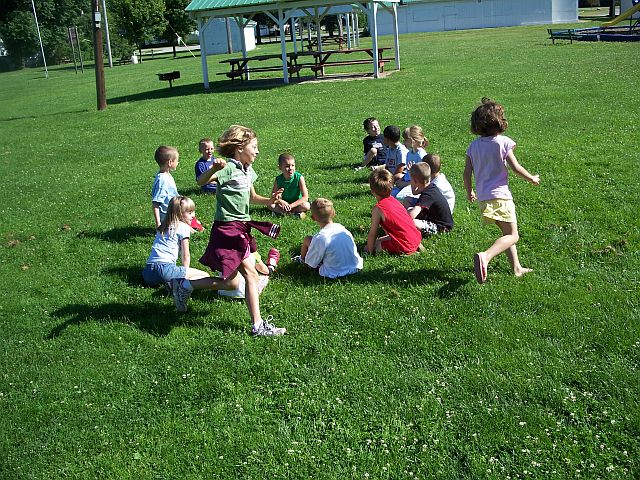 Some Children playing Duck Duck Goose